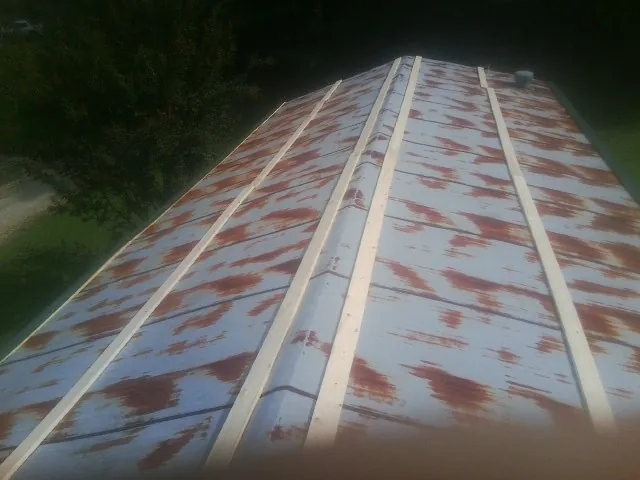Rusted metal roof panels with new wood purlins before replacement — Storm Damage Roof Repair in Gibson Island by Roofing Brothers